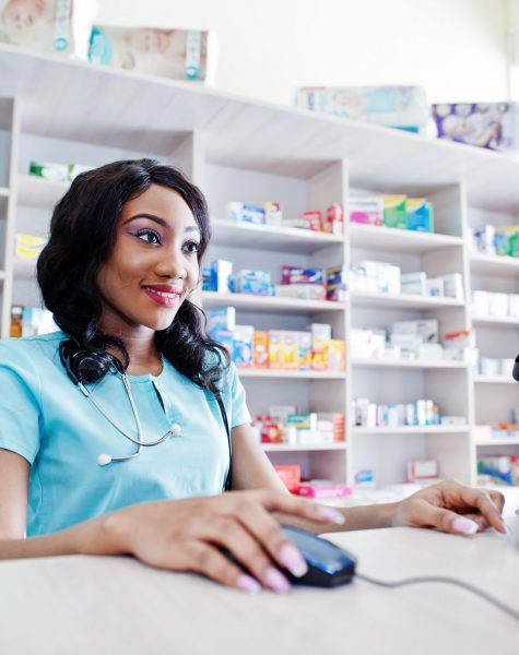 African american pharmacist cashier working in drugstore at hospital pharmacy. African healthcare.